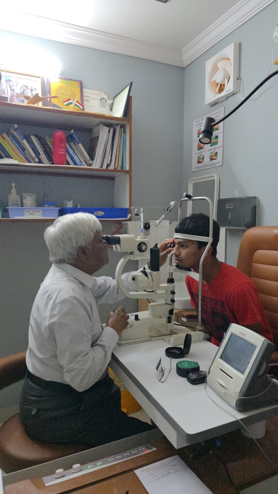 Ophthalmologist examining a patient at the slit lamp